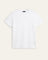 A plain white short-sleeve crewneck t-shirt laid flat against a light beige background.